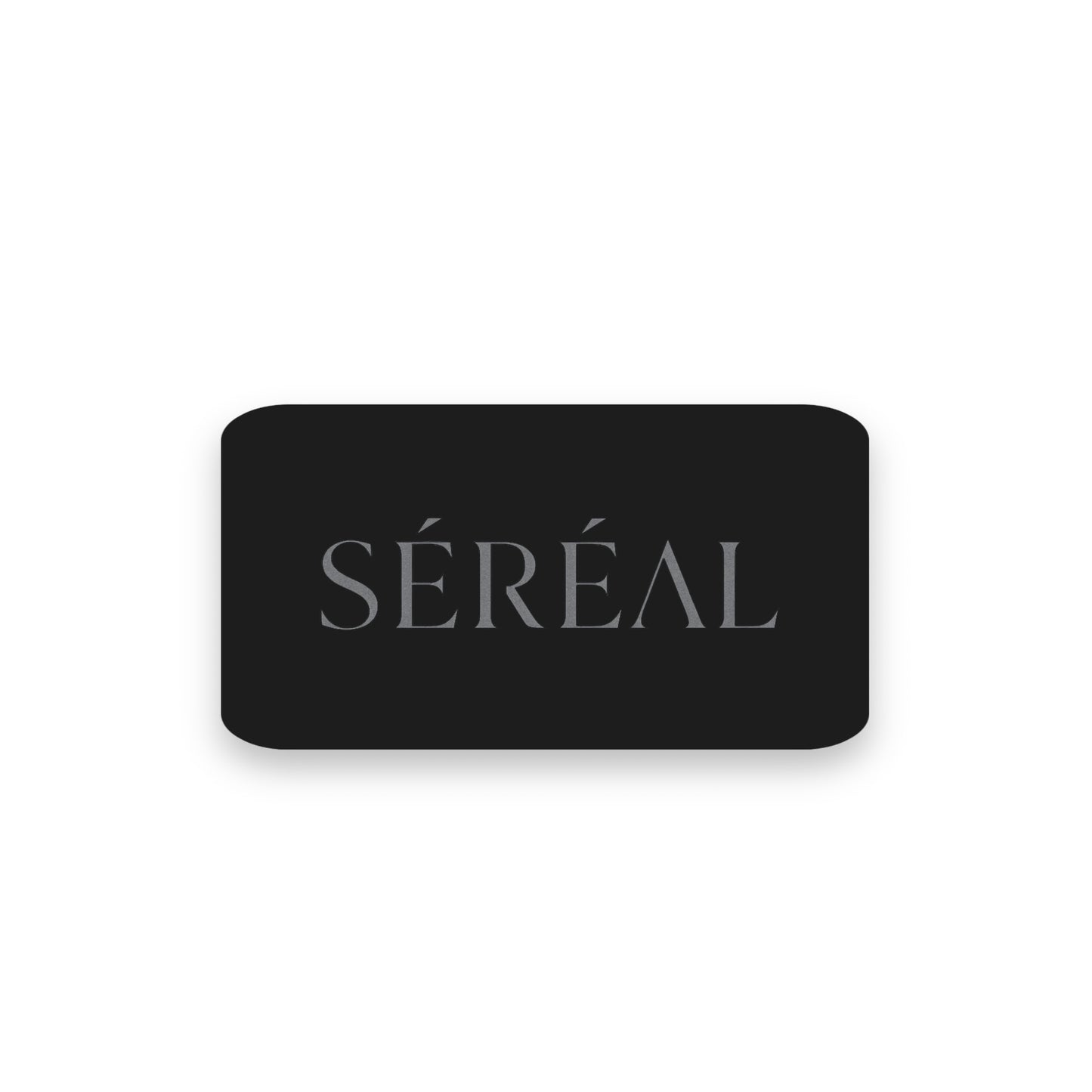 A black rectangular card with "SÉRÉAL" in gray uppercase letters is centered on white, embodying modern luxury—the ideal SÉRÉAL Digital Gift Card for any 3D-printed handbag lover.